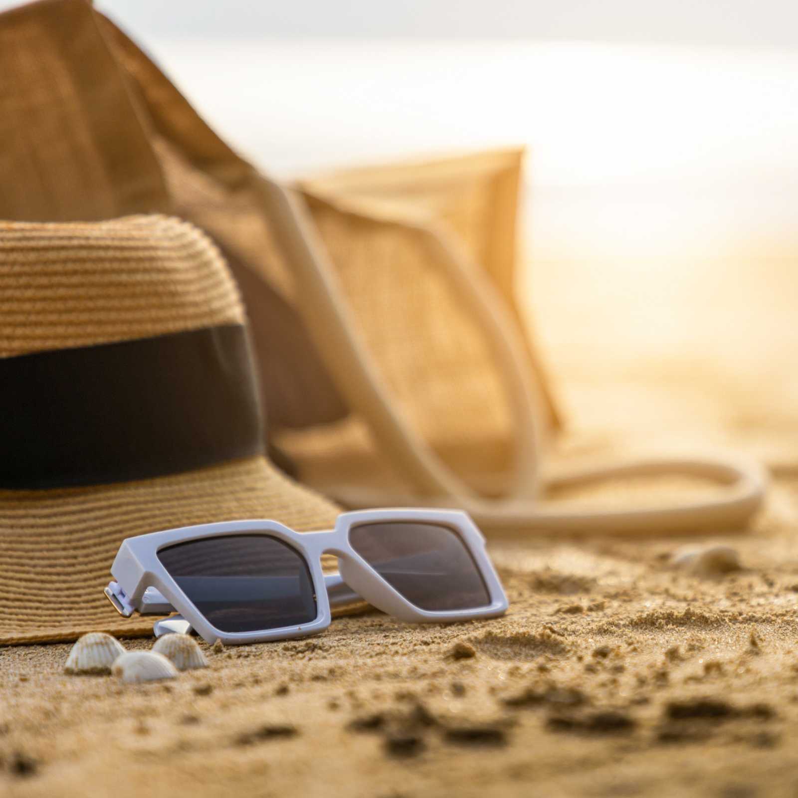 sunglasses on a pile of sand on beach