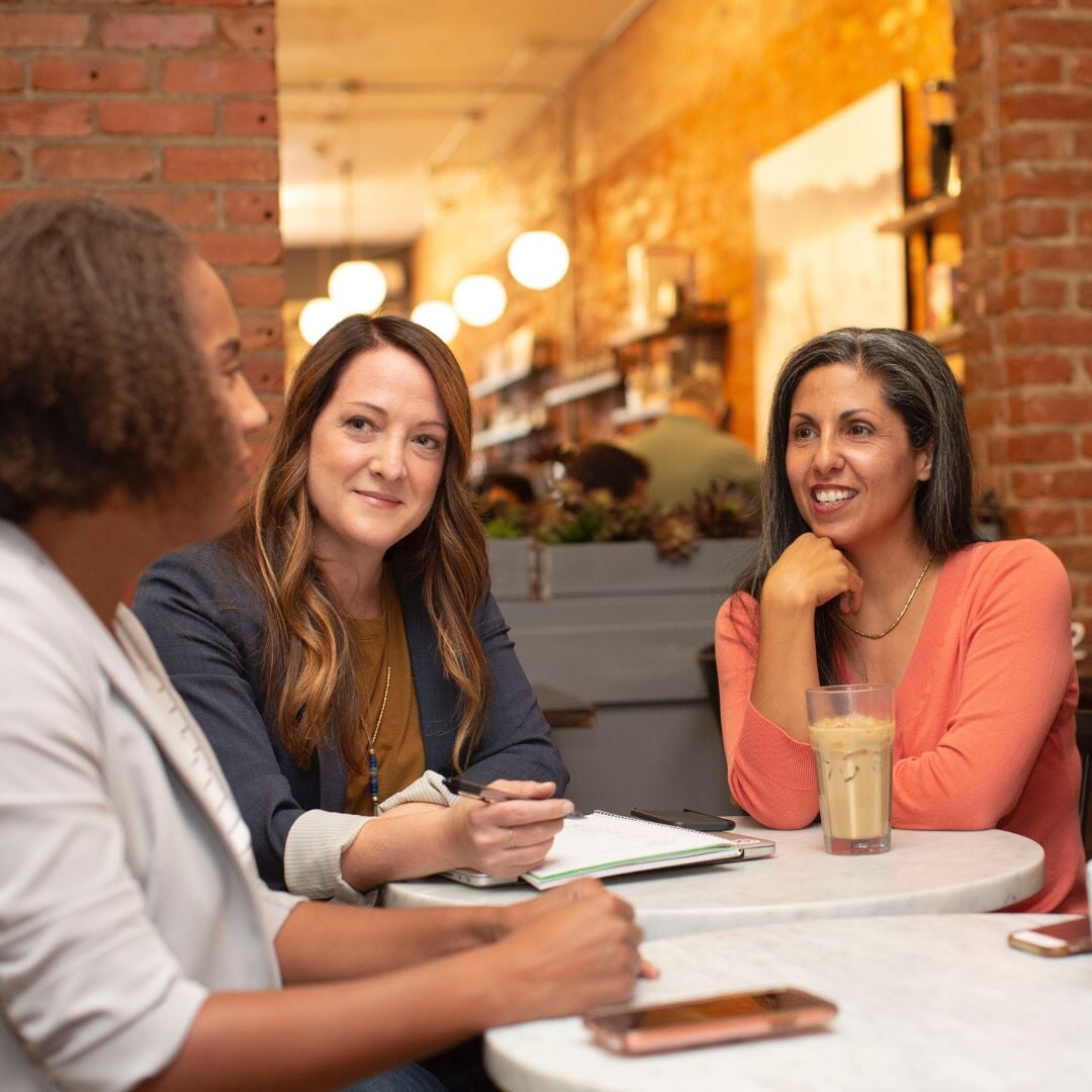 group of women talking at a table