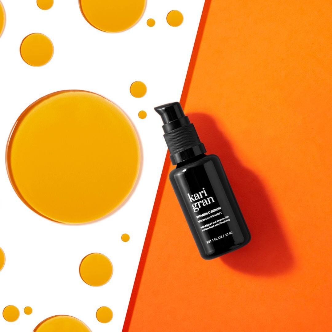 kari gran vitamin c serum on orange background with oil spots