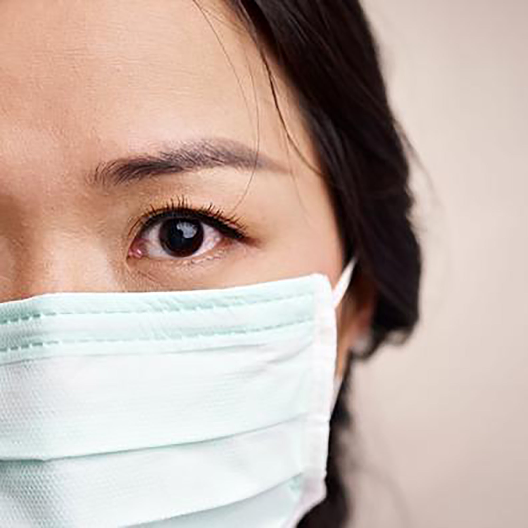 woman wearing mask facing camera