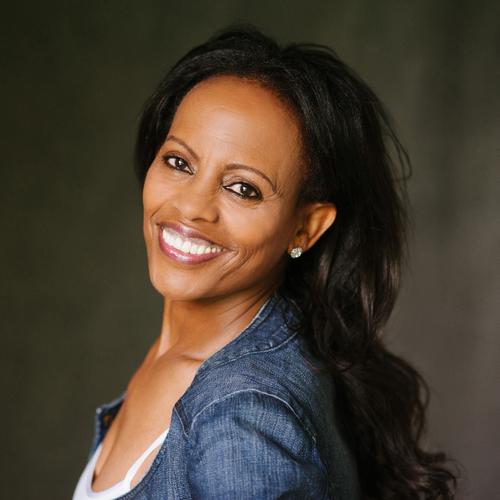 image of woman smiling and looking over shoulder
