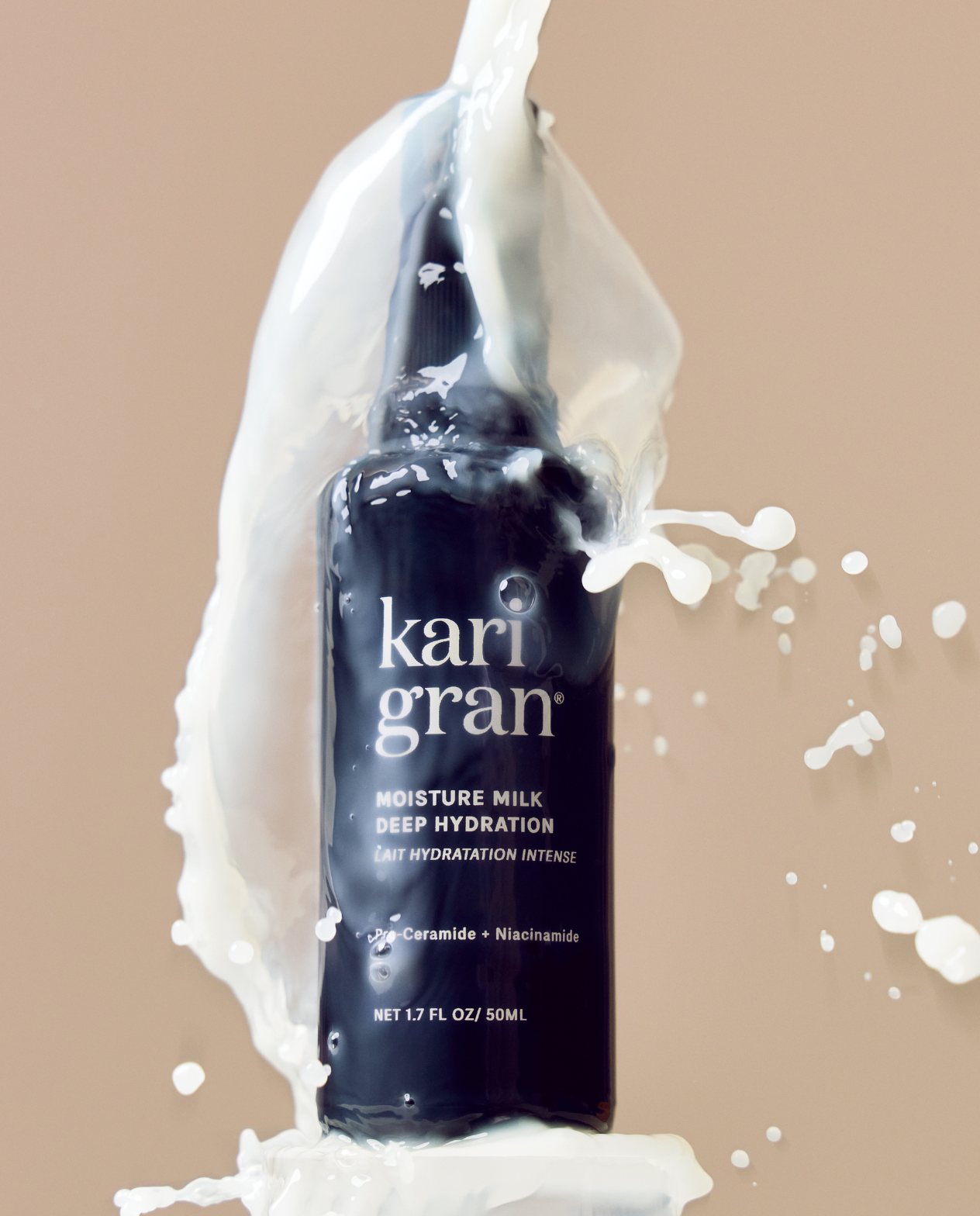 Kari Gran Moisture Milk bottle with white cream splashes on a beige background
