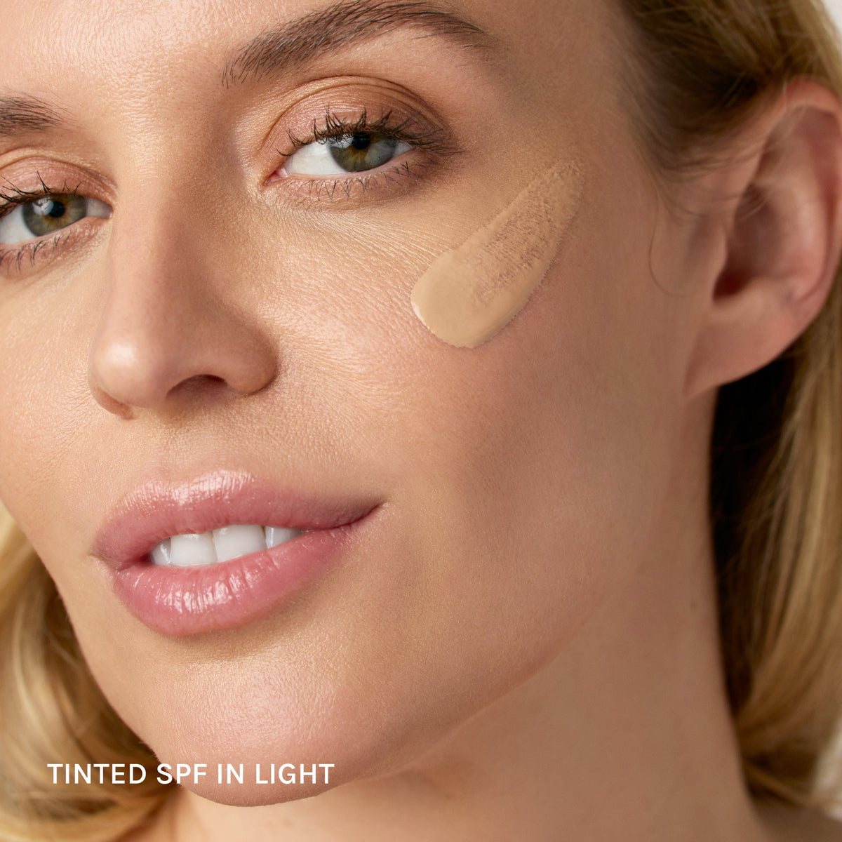 model wears essential tinted spf in light