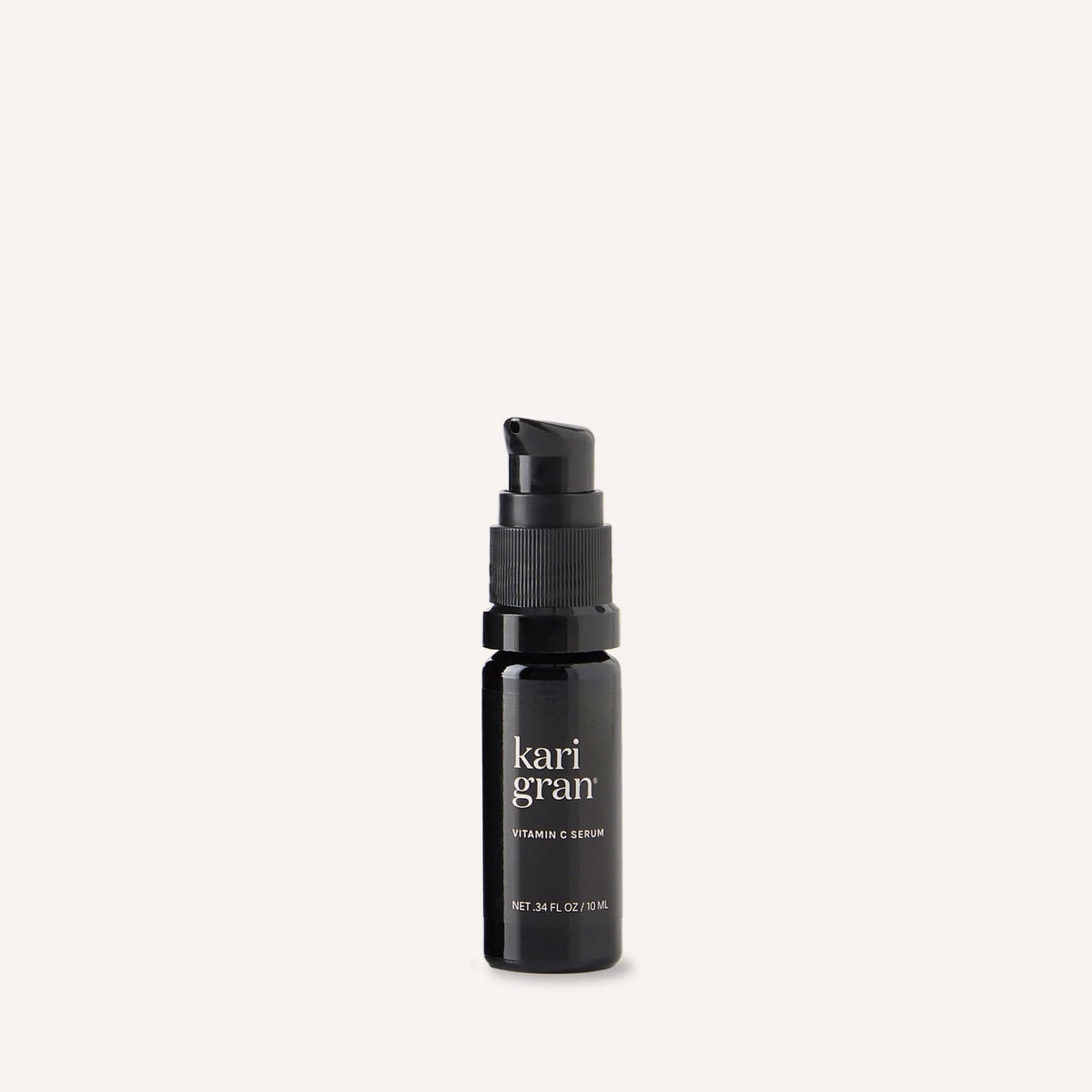 Black serum bottle with 'kari gran' branding on a white background