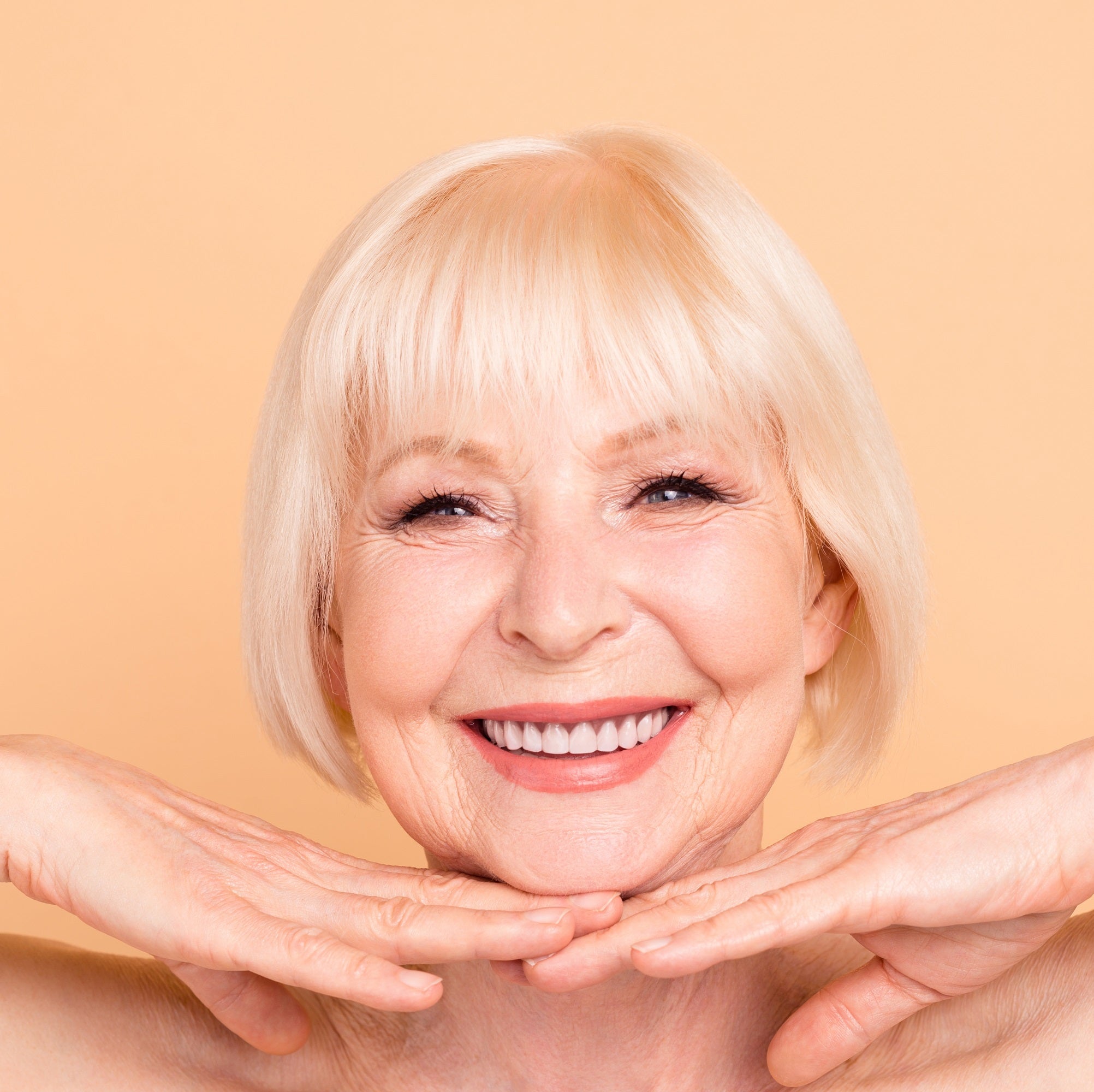 older woman holding face