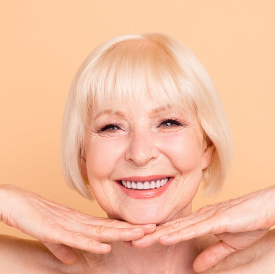 older woman holding face