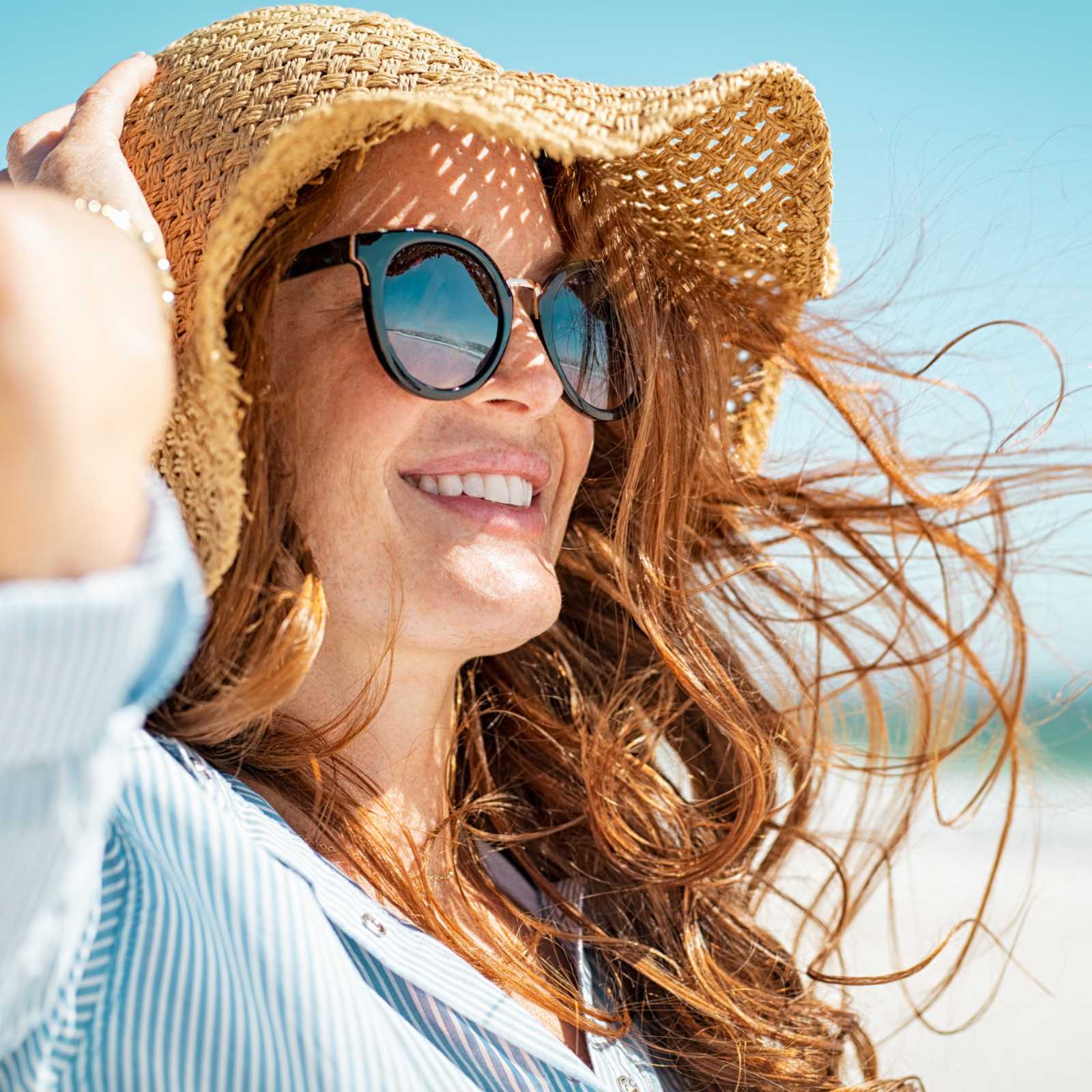 woman wearing sunglasses and a sun hat