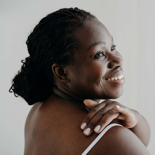women rubbing her shoulder 