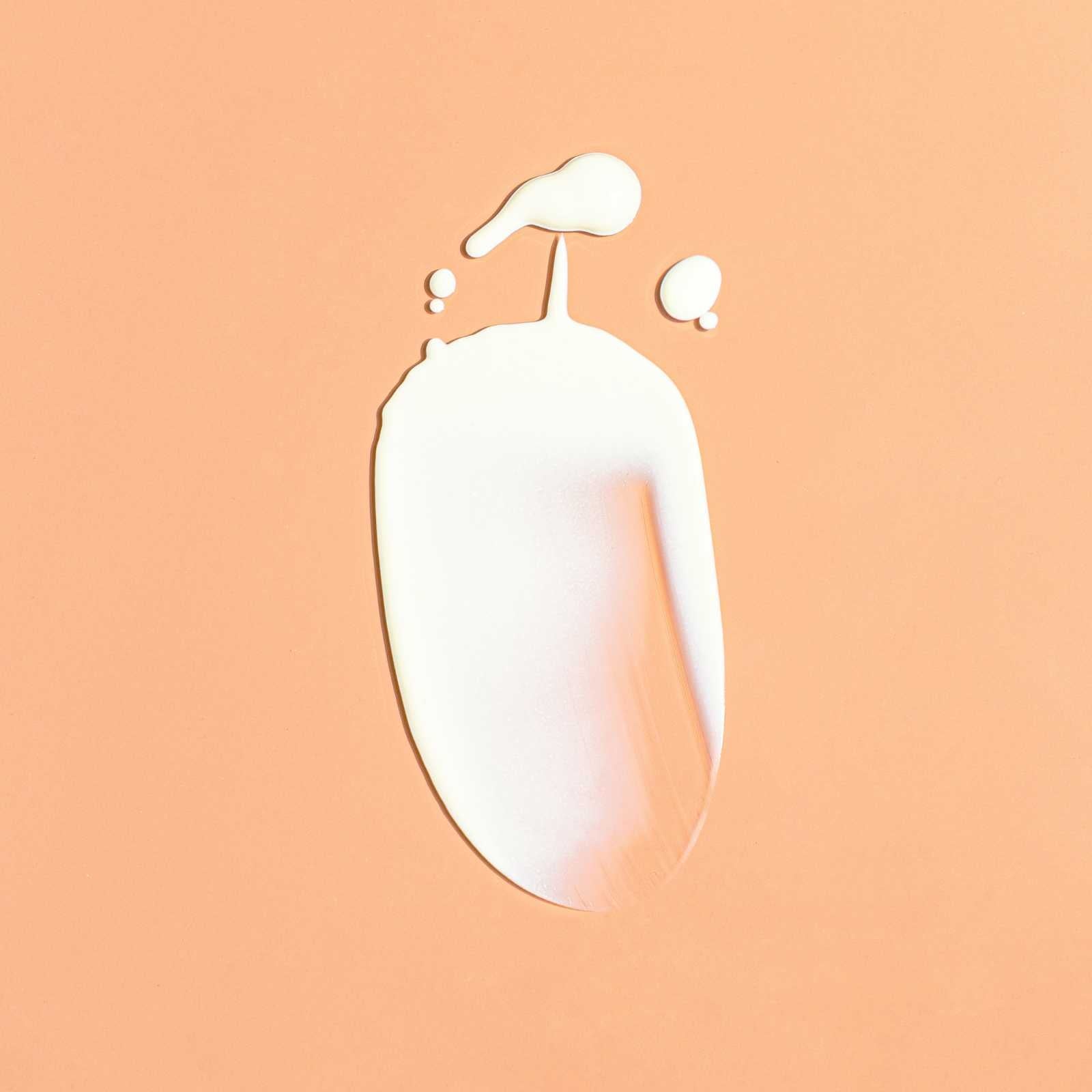 swatch of essential spf on a beige background