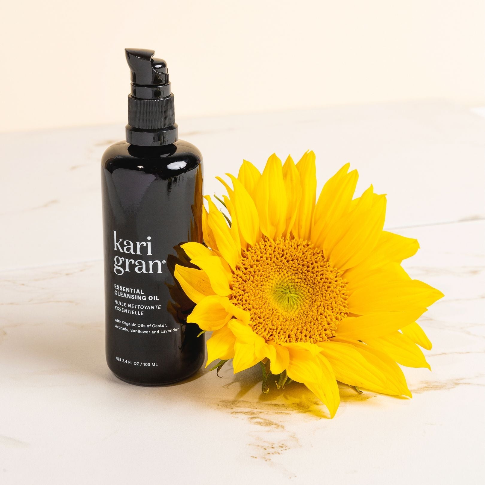 kg cleansing oil next to a sunflower on table