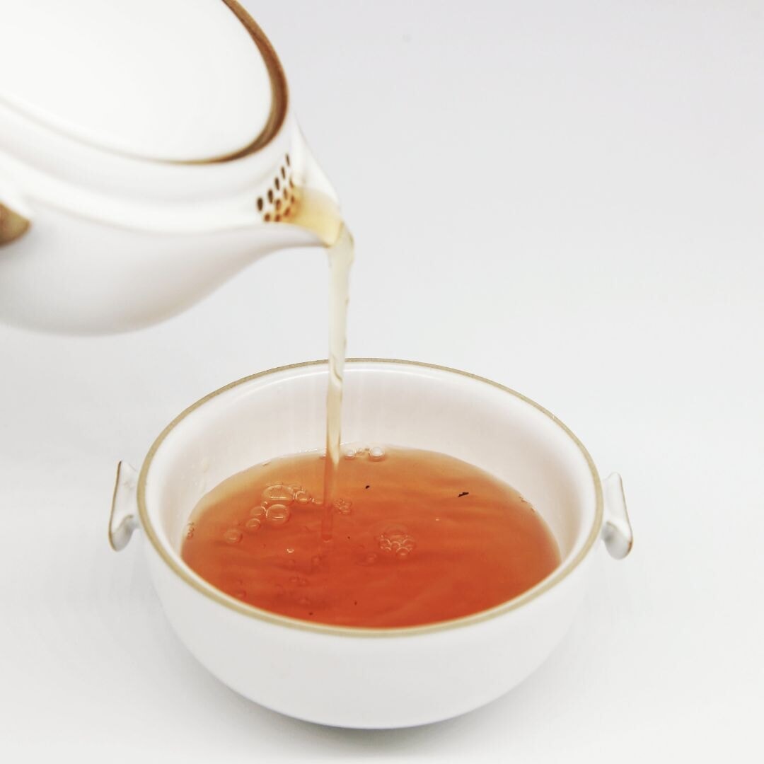 tea pouring into a cup