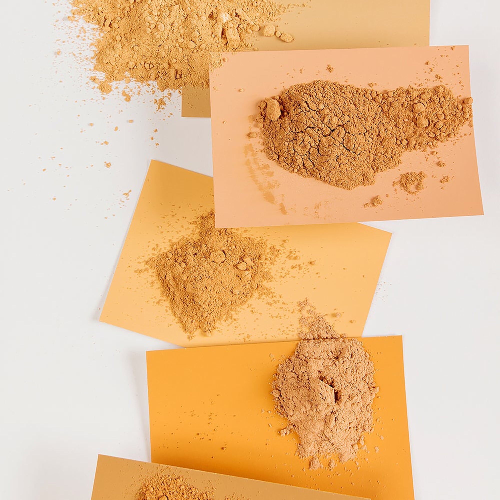 mineral makeup piles on colored paper