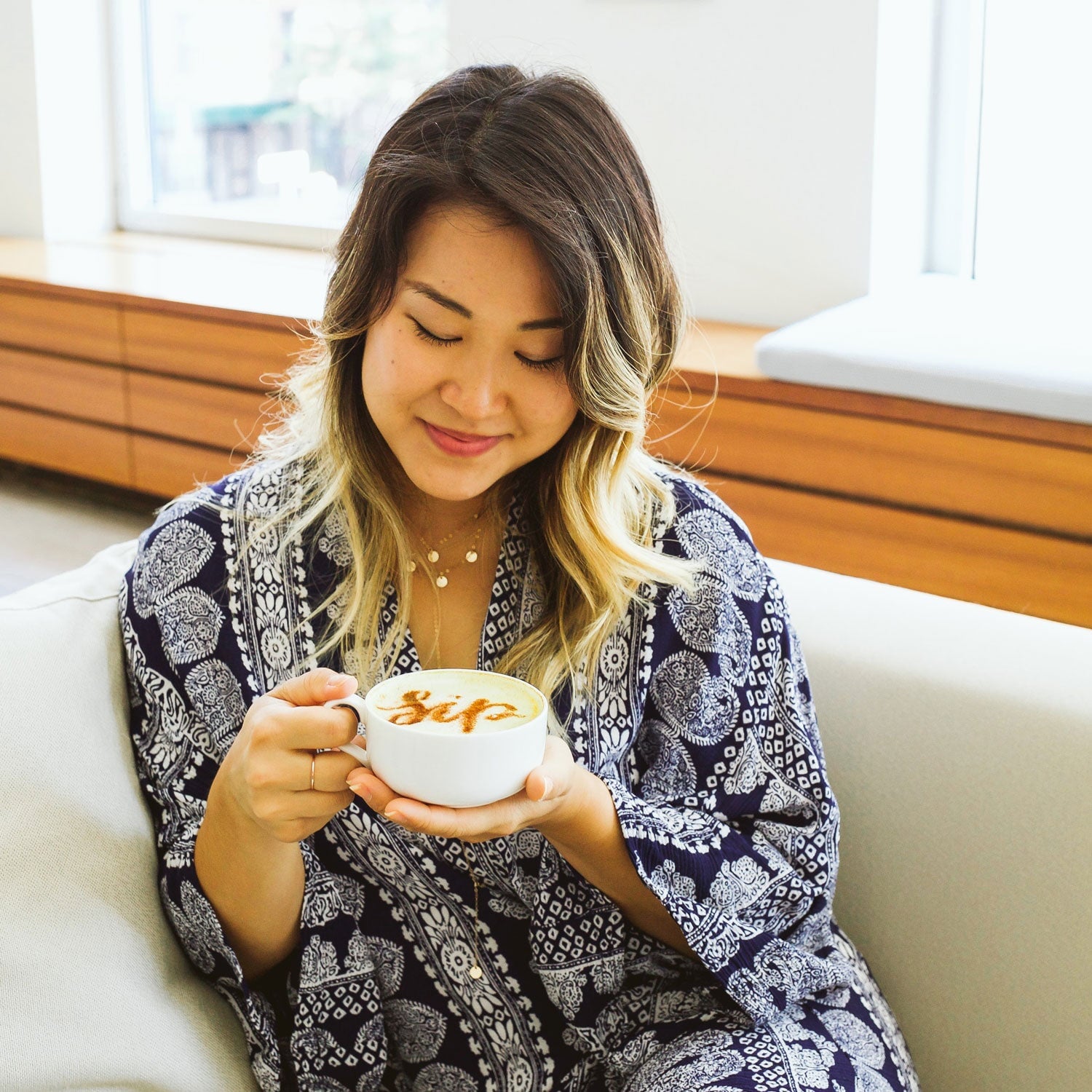 Image of Minna Lee enjoying a cup of coffee