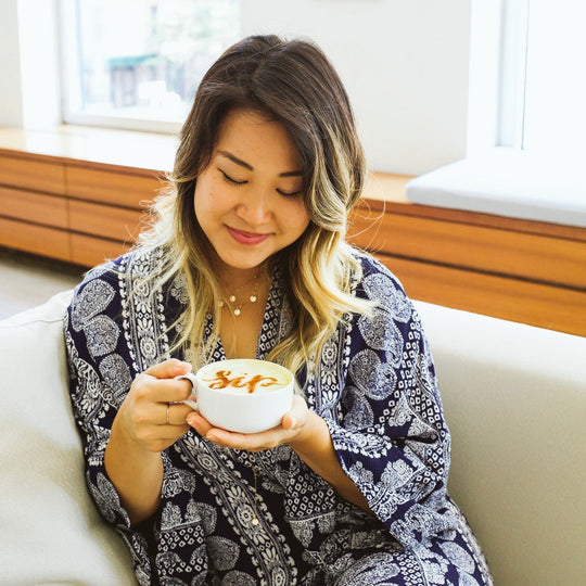 Image of Minna Lee enjoying a cup of coffee