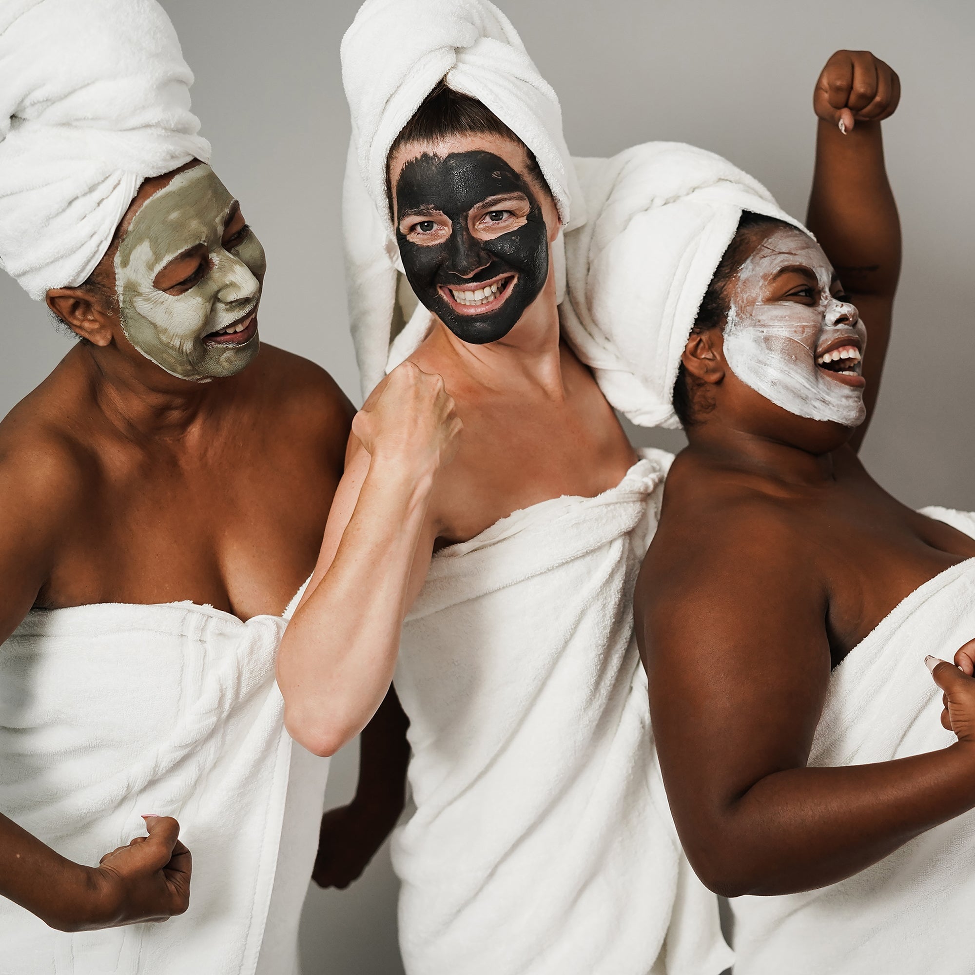 women of all ages in towels wearing a skincare face mask