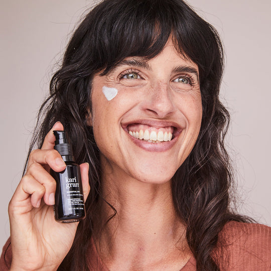 mineral spf- model wearing and holding the KG Essential SPF 30