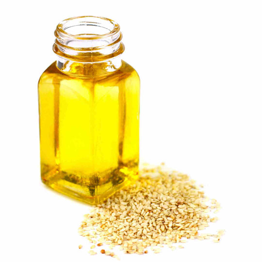 sesame oil and bottle on white background