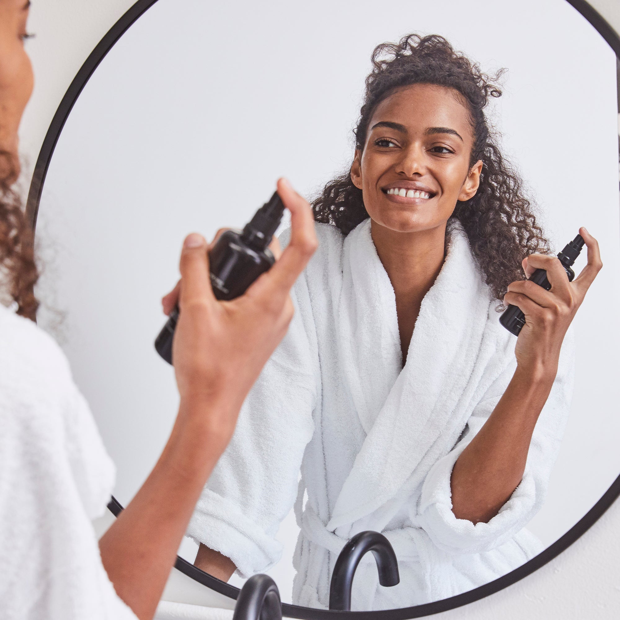 woman spraying Kari Gran Essential Hydrating Tonic