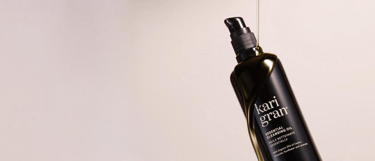 kari gran essential serum balm with swipes of product next to the jar