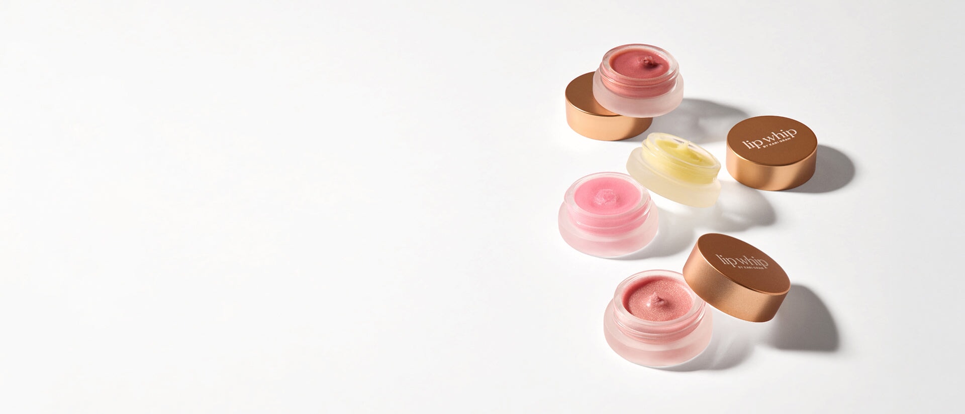 kari gran variety of Lip Whip shades with the tops off to show off color