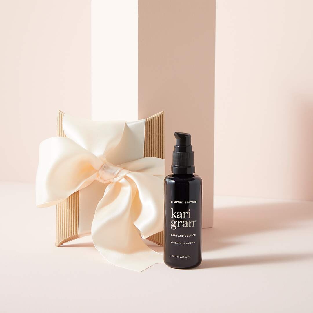 Holiday Body Oil with a bow behind it