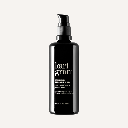Black bottle of kari gran cleansing oil on a white background