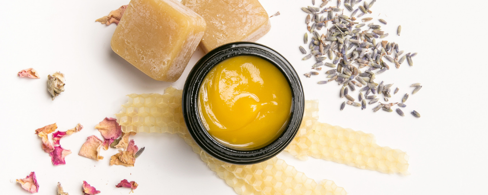Essential balm surrounded by ingredients