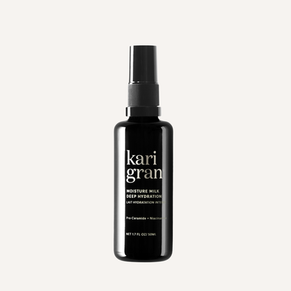 Black bottle of kari gran moisture milk on a white background