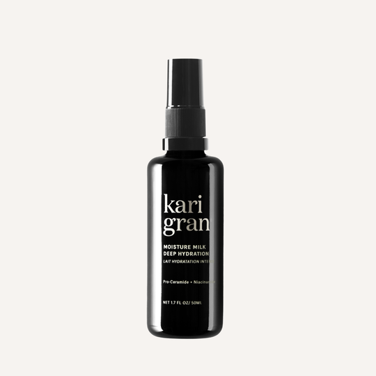 Black bottle of kari gran moisture milk on a white background