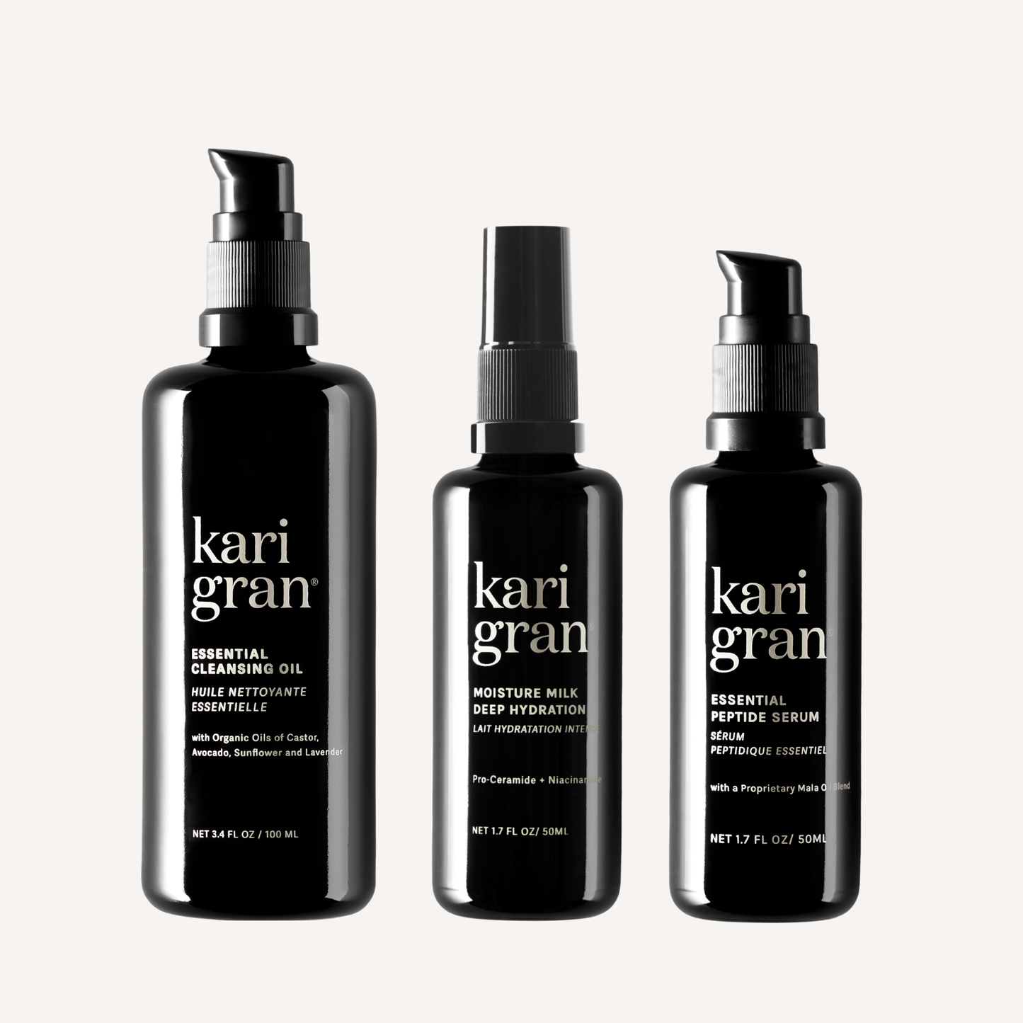 Three black bottles of kari gran skincare products on a white background