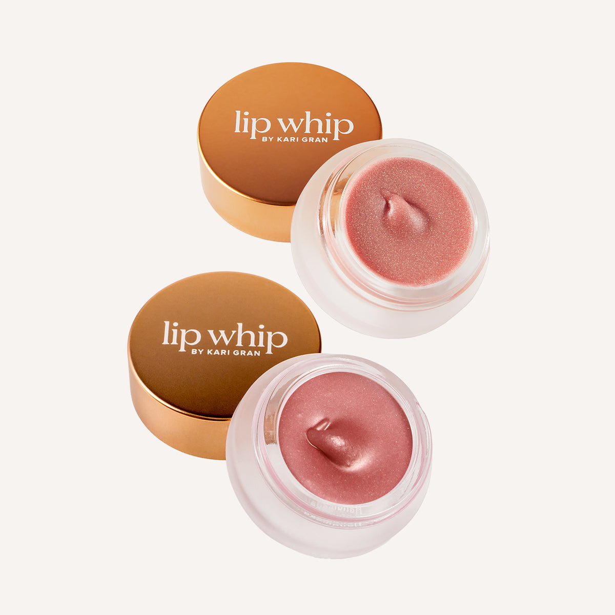 Two containers of lip whip by Kari Gran with a light pink lip balm on a white background.