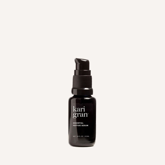 Black serum bottle with 'kari gran' branding on a white background