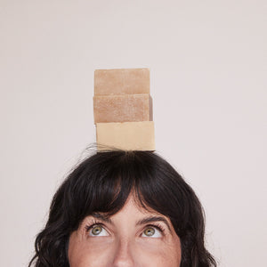 Kari Gran Essential Bar Soap stacked on woman's head