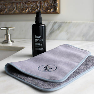 Kari Gran Essential Cleansing Oil & Luxe Exfoliating Washcloth on sink